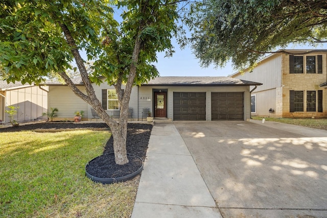 view of front of house with a front yard and a garage