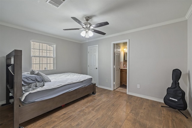 bedroom with connected bathroom, ornamental molding, wood-type flooring, and ceiling fan