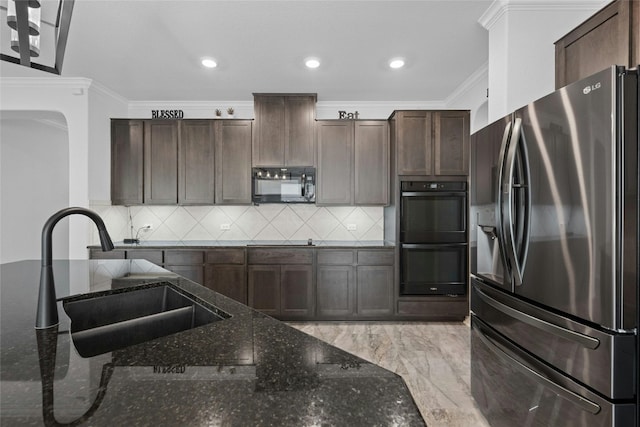 kitchen featuring ornamental molding, dark stone countertops, black appliances, dark brown cabinetry, and sink