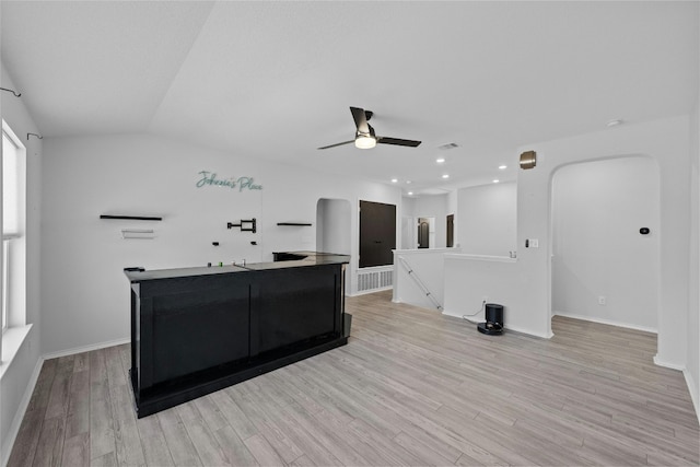 interior space featuring vaulted ceiling, light hardwood / wood-style floors, and ceiling fan