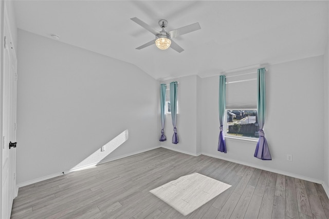 unfurnished room featuring vaulted ceiling, light hardwood / wood-style flooring, and ceiling fan