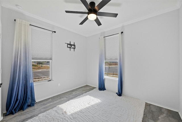 spare room featuring crown molding, a healthy amount of sunlight, wood-type flooring, and ceiling fan