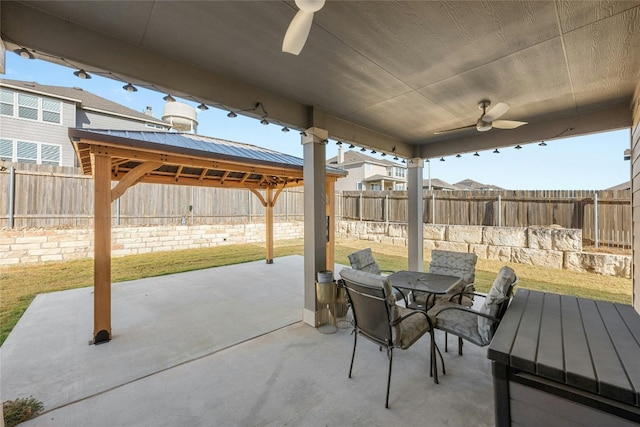 view of patio / terrace featuring a gazebo and ceiling fan