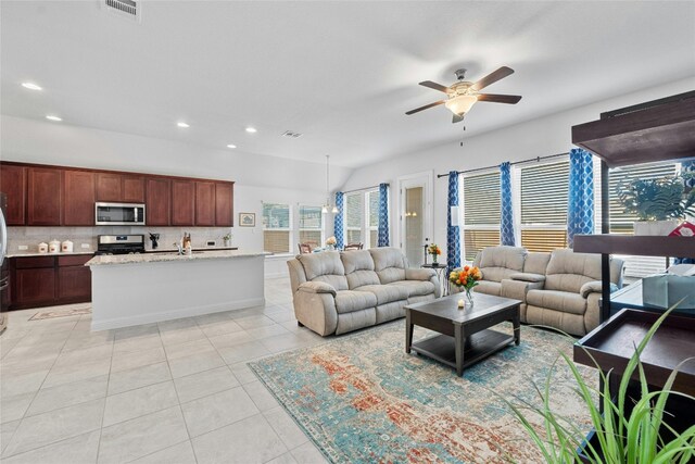 living room featuring light tile patterned flooring and ceiling fan