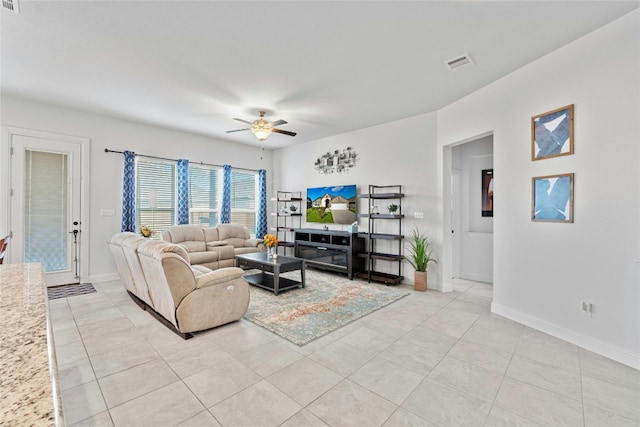 tiled living room with ceiling fan