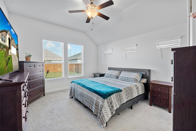 carpeted bedroom featuring vaulted ceiling and ceiling fan