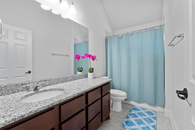 bathroom featuring vanity, vaulted ceiling, toilet, and tile patterned flooring