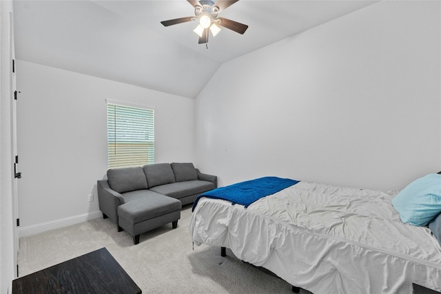 bedroom with vaulted ceiling, light carpet, and ceiling fan