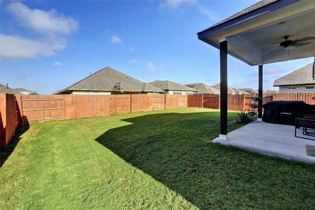 view of yard with a patio and ceiling fan