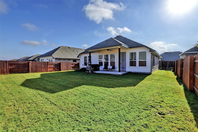 rear view of house with a patio area and a lawn