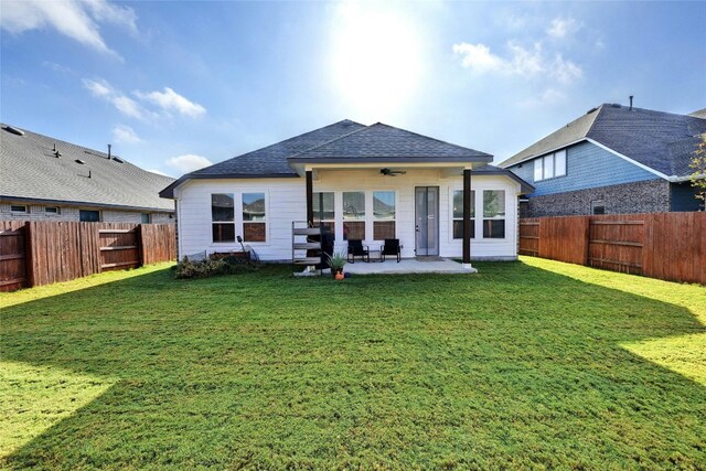 back of house featuring a patio and a lawn