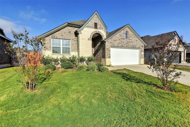 view of front of property with a front yard and a garage