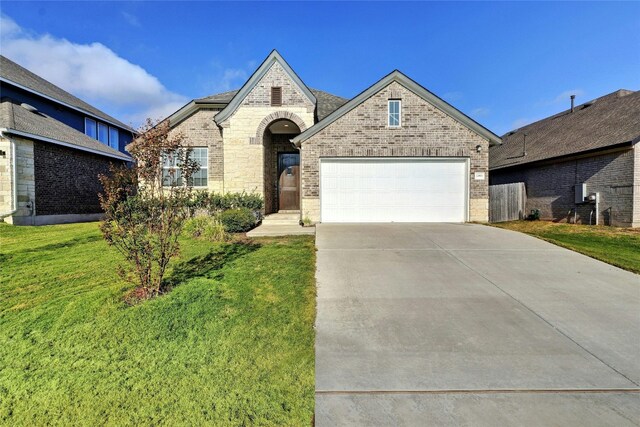 view of front of home featuring a front lawn and a garage