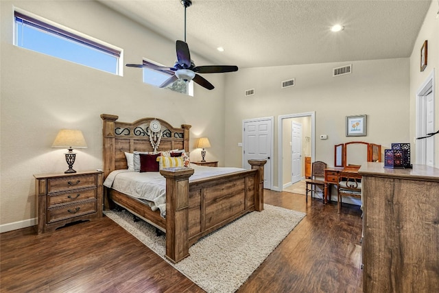 bedroom with a textured ceiling, high vaulted ceiling, dark wood-type flooring, and ceiling fan