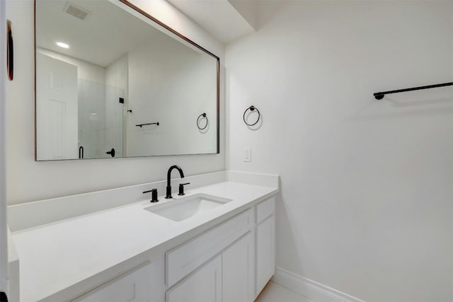 bathroom with vanity and a shower with shower door