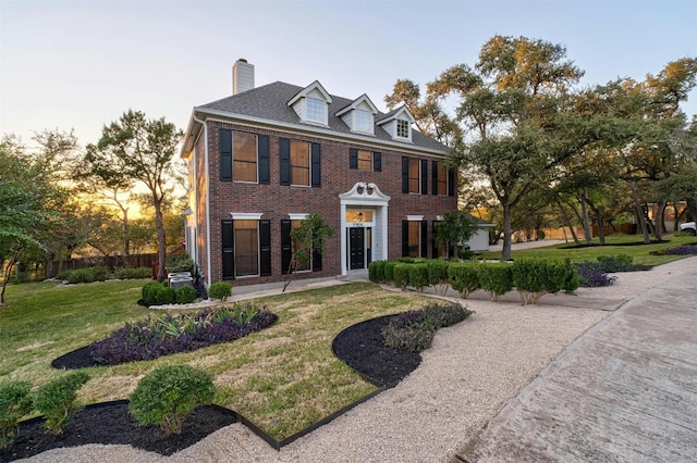 colonial home with a yard