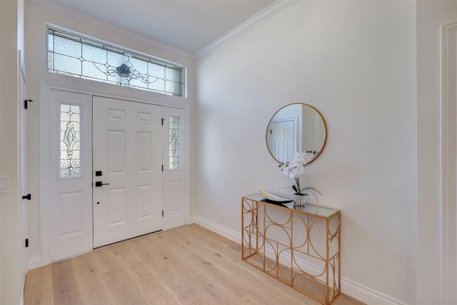 foyer with crown molding and light hardwood / wood-style floors