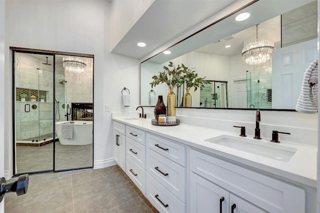 bathroom featuring vanity, separate shower and tub, a chandelier, and tile patterned floors