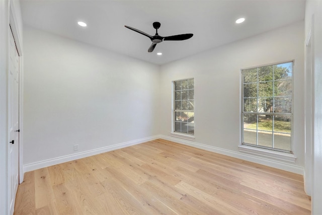 spare room featuring light hardwood / wood-style flooring and ceiling fan