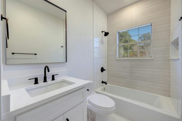 full bathroom with toilet, tiled shower / bath combo, and vanity