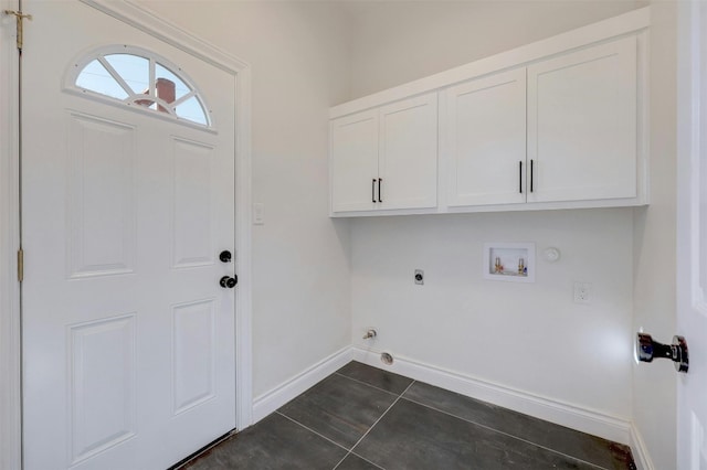 clothes washing area featuring cabinets, washer hookup, dark tile patterned floors, electric dryer hookup, and hookup for a gas dryer