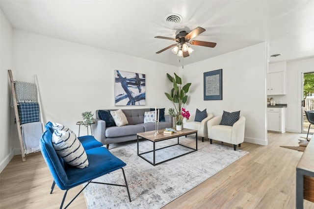 living room featuring light hardwood / wood-style floors and ceiling fan