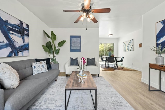 living room featuring light hardwood / wood-style floors and ceiling fan