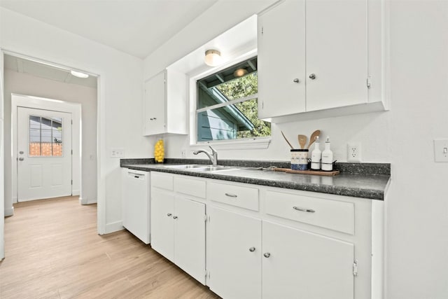 kitchen featuring sink, dishwasher, white cabinetry, and light hardwood / wood-style floors