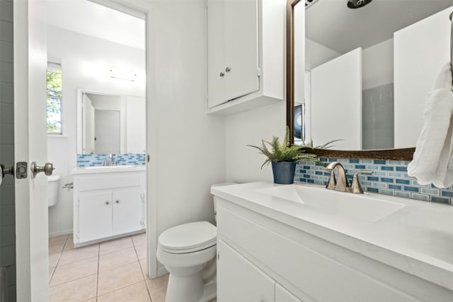 bathroom with vanity, decorative backsplash, toilet, and tile patterned floors