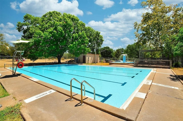 view of swimming pool with a storage shed