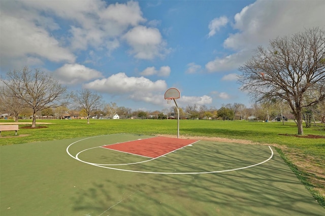 view of basketball court with a yard