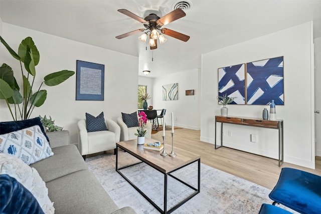 living room with light hardwood / wood-style flooring and ceiling fan