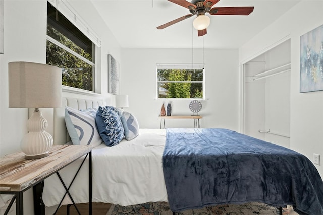 bedroom with wood-type flooring, a closet, and ceiling fan