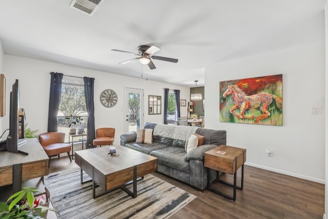 living room with dark hardwood / wood-style floors and ceiling fan