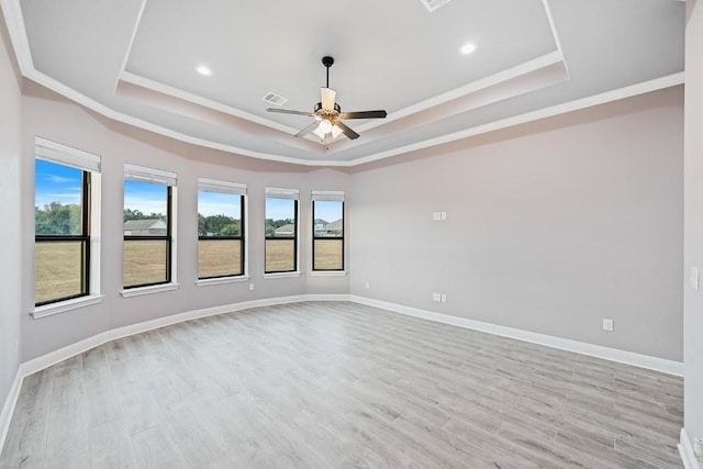 124 Park Place Dr, Georgetown, TX 78628 - empty room featuring a tray ceiling, a ceiling fan, crown molding, light wood-style floors, and recessed lighting
