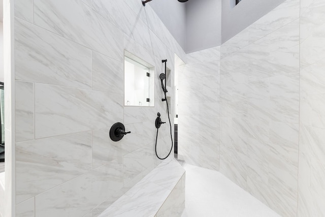 bathroom with a tile shower