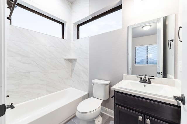 full bathroom featuring vanity, toilet, tiled shower / bath, and a healthy amount of sunlight