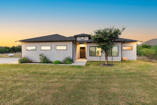 prairie-style house featuring a lawn