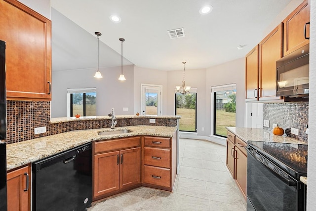124 Park Place Dr, Georgetown, TX 78628 - kitchen with black appliances, a peninsula, brown cabinetry, and recessed lighting