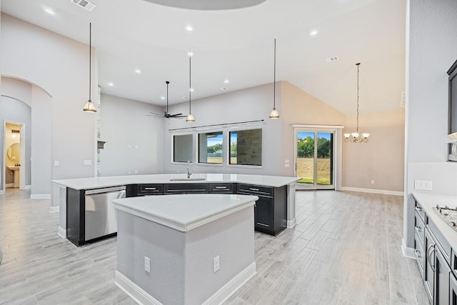 124 Park Place Dr, Georgetown, TX 78628 - kitchen with stainless steel dishwasher, a center island, light wood-style flooring, light countertops, and high vaulted ceiling