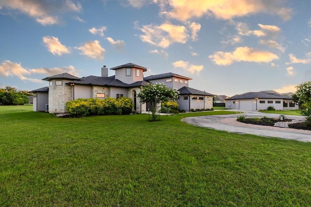 124 Park Place Dr, Georgetown, TX 78628 - view of front facade with driveway, a front lawn, stone siding, and a chimney