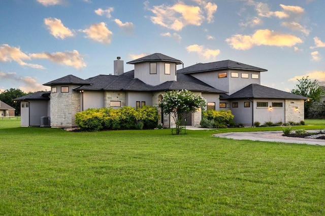 124 Park Place Dr, Georgetown, TX 78628 - prairie-style home featuring a chimney, stone siding, a front lawn, and stucco siding