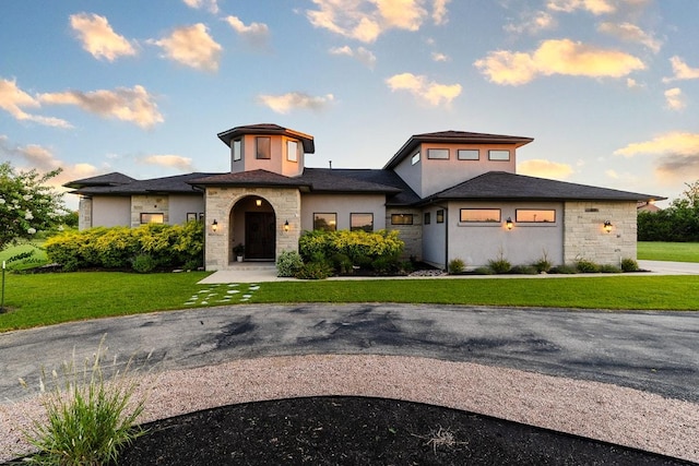 124 Park Place Dr, Georgetown, TX 78628 - view of front facade with stone siding, a front yard, and stucco siding