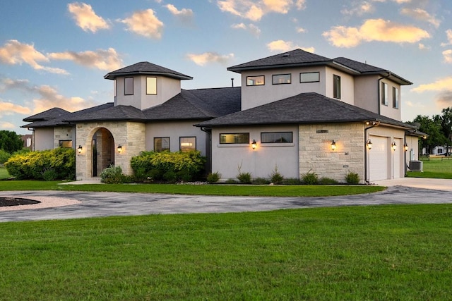 124 Park Place Dr, Georgetown, TX 78628 - view of front facade featuring stone siding, concrete driveway, a front yard, and stucco siding