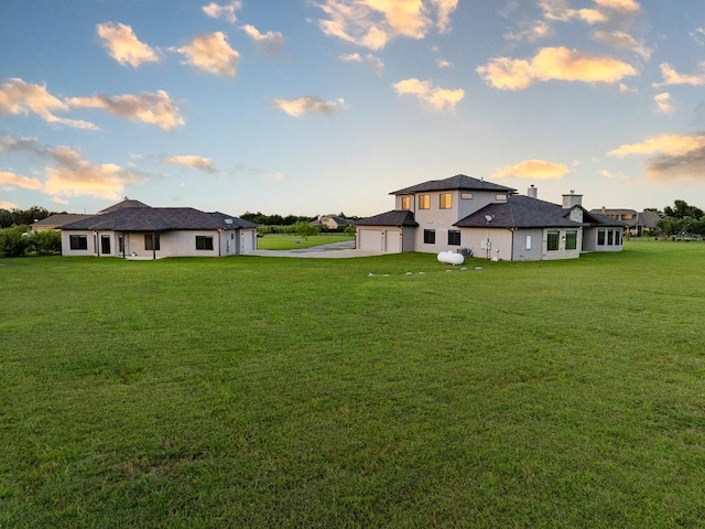 124 Park Place Dr, Georgetown, TX 78628 - rear view of property with a lawn, concrete driveway, and an attached garage