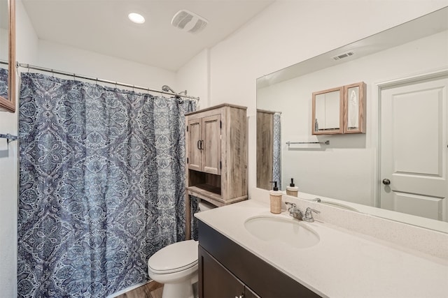 bathroom with hardwood / wood-style flooring, vanity, toilet, and a shower with shower curtain