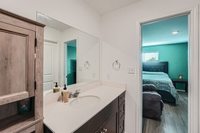 bathroom featuring hardwood / wood-style flooring and vanity