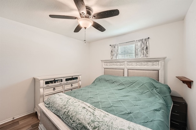 bedroom featuring ceiling fan and hardwood / wood-style flooring