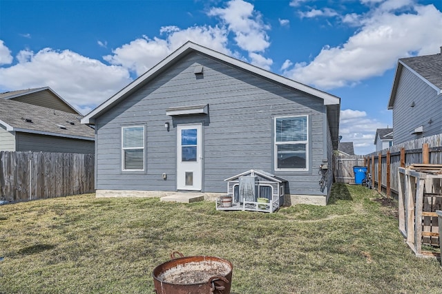 rear view of property featuring a yard