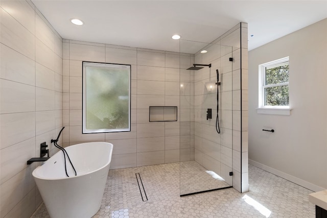 bathroom featuring tile walls, separate shower and tub, and tile patterned flooring